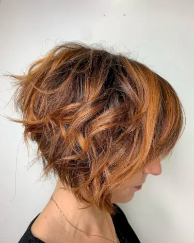 short layered dark copper brown hair with caramel highlights