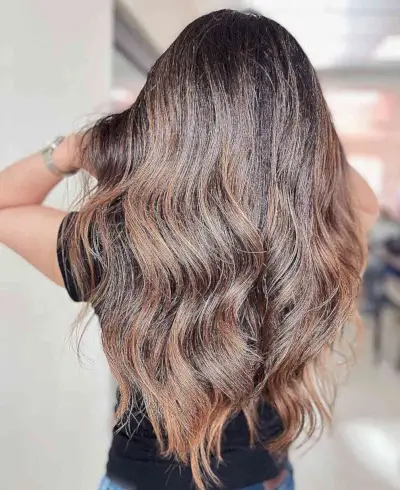 Dimensional Caramel Highlights on Wavy Dark Brown Hair