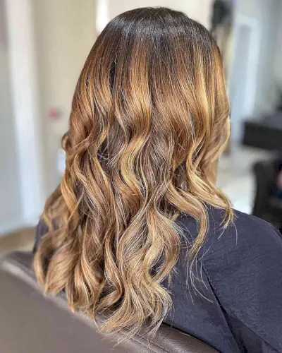 Dark-Rooted Caramel Bronde Ombre Hair Highlights on Medium Cut with Loose Curls