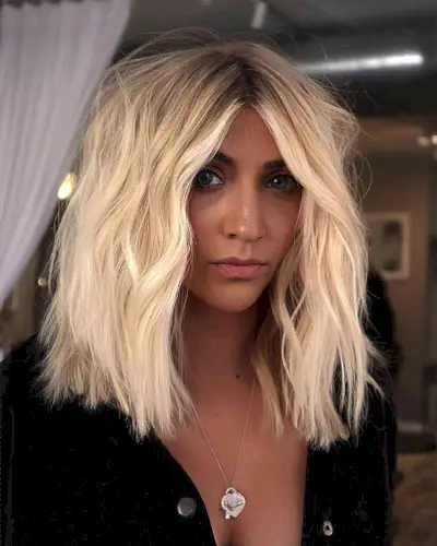 Full and Thick Platinum Cut for women with darker skin and light hair with dark roots