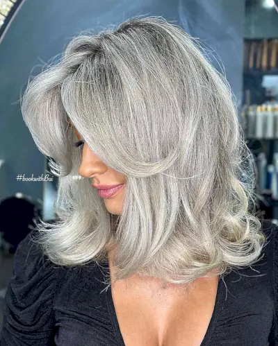 Platinum Grey with a Shadow Root on Medium-Length Feathered Hair