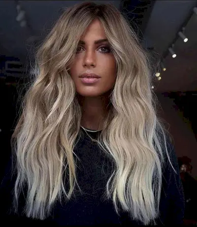 Melted Buttery Platinum Blonde with Lighter Ends and Darker Roots for Wavy Hair