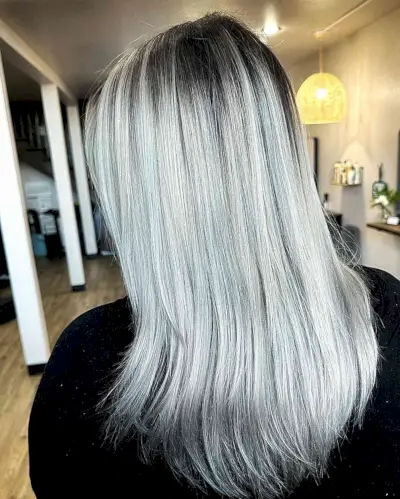 Icy Silver with Black Roots on Mid-Length Hair with Wispy Layers 
