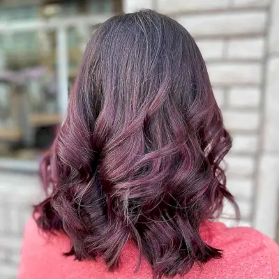 Burgundy Balayage Highlights on Shoulder-Length Cut with Thick Waves