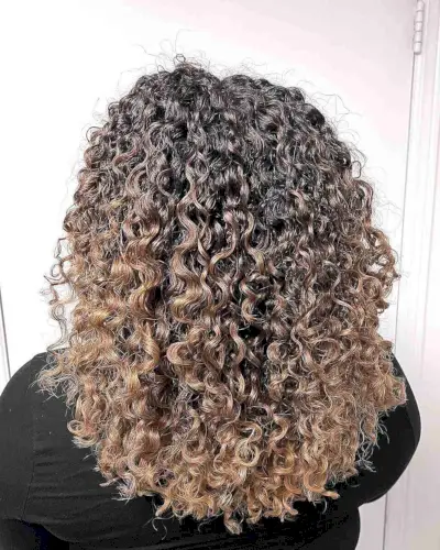 Tight Curls with Melted Warm Blonde Balayage Color