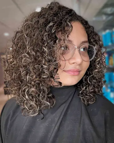 Dark Curls with Hints of Blonde Balayage for Curly Hair