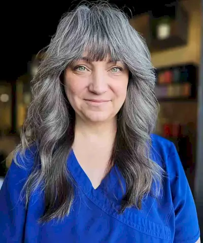 Natural Grey Balayage on Medium Wavy Hair with Bangs for Older Women