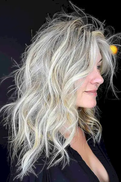 Long layered wavy hair with multi-dimensional silver and blonde tones