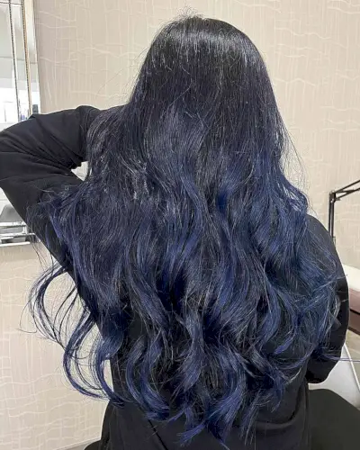 Deep Blue Balayage Streaks for Long-Length Black Hair with Soft Waves