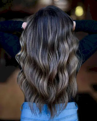 Glossy Dark Brown Balayage with Blonde Tones for women with long wavy hair