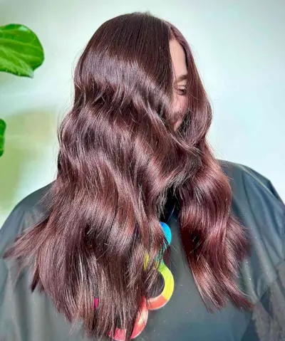 Blended Cherry and Mahogany Highlights on Longer Locks with Choppy Ends