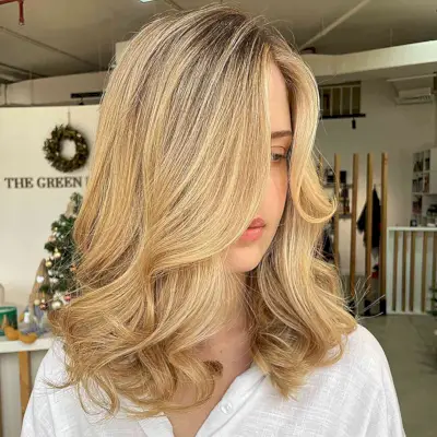 Dark-Rooted Bright Honey Blonde with Warm Highlighted Tones for Medium Hair