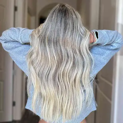 Long Icy Blonde Balayage Waves with Darker Roots and Soft Waves