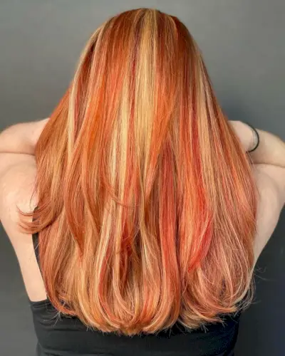 Trendsetting Blonde with red highlights