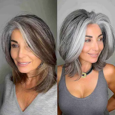 Medium-length fluffy platinum and silver balayage hairstyle on a mature woman