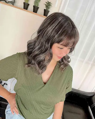 Mid-Length Brown Balayage Waves with Grey Highlights and Thin Bangs