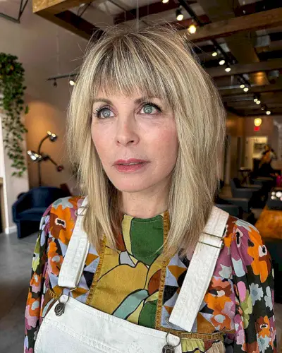 Shoulder-Length Bright Blonde Balayage Hair with Choppy Layers and Bangs