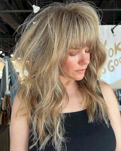 Golden Balayage on Medium-Length Messy Shag with Bangs