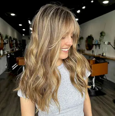Long Wavy Hair with Caramel Blonde Balayage Highlights and Face-Framing Fringe