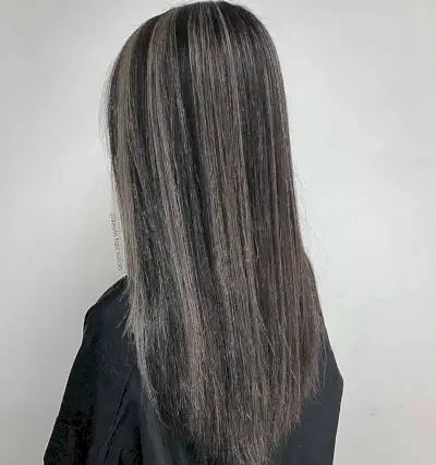 Muted Blended Grey Streaks on Long-Length Black Hair