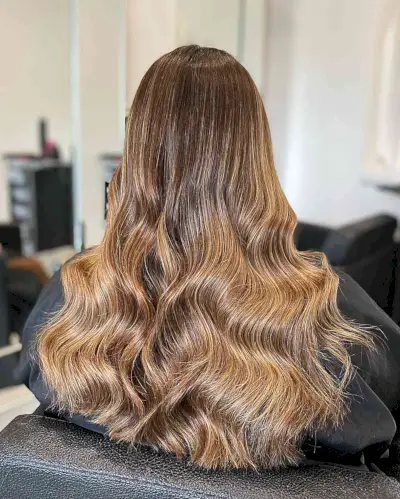 Long Wavy Hair with Warm Caramel Balayage and Blonde Hues
