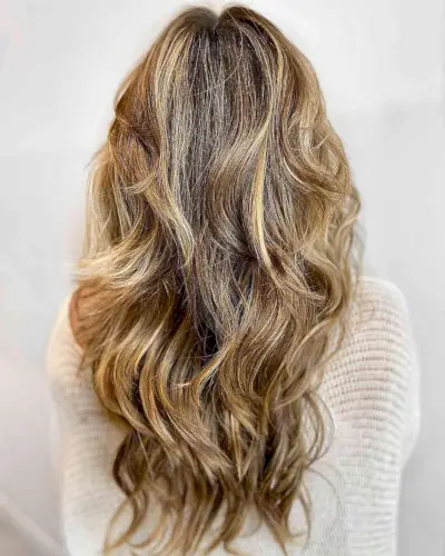 Long Dimensional Sun-Kissed Warm Blonde Balayage Hair with Messy Waves