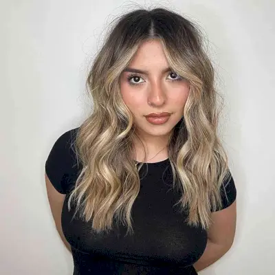 Casual Blonde Balayage with Middle-Parted Dark Roots