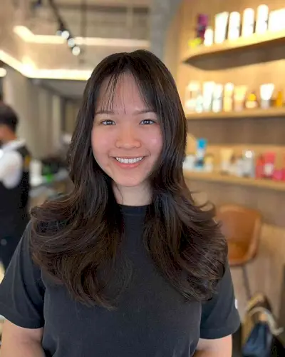 Long Layered Butterfly Cut with Subtle Bangs for Fuller Face Shapes