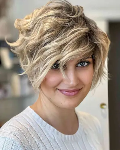 Heavily Layered Bob with a Deep Side Part and blonde highlights
