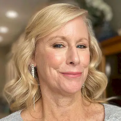 Blonde Waves with Sweeping Bangs and a Deep Side Part for women over 60 