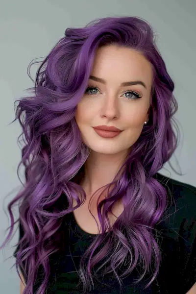 Woman with purple curls and long layered haircut, styled for a party.