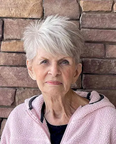 Edgy White Razored Layers with side-swept bangs for older women over 70