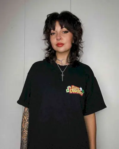 Textured mullet hairstyle with soft fringe inclusive hairstyle