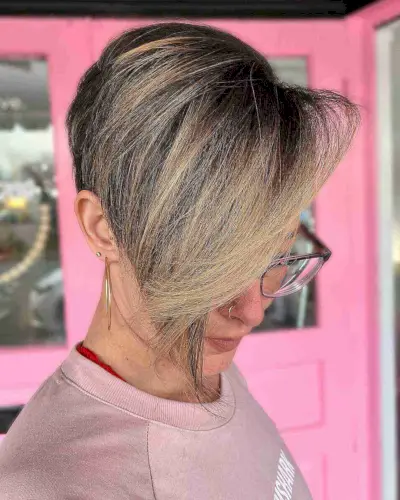 Asymmetrical pixie gender neutral haircut with long side fringe