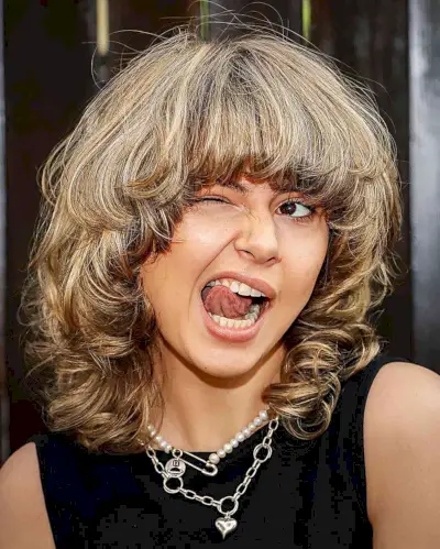 Vintage 80s Face-Framing Layers with Heavy Bangs for Shoulder-Length Hair