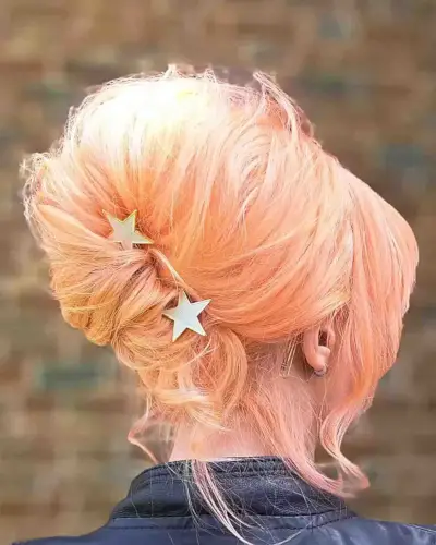 80s-Inspired Peach Beehive Hairstyle with Star Hair Accessories
