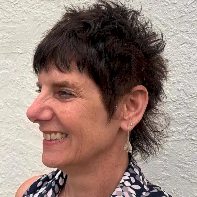 Short textured mullet with tousled layers and choppy fringe on thick hair