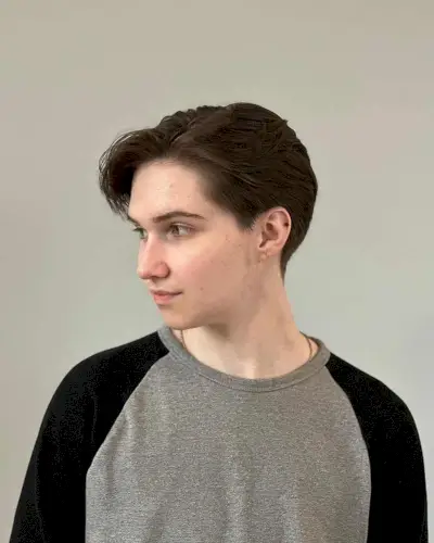 Sleek tapered cut with a side part and smooth finish on fine to medium hair