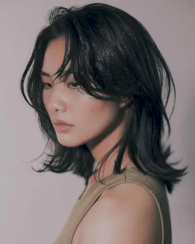 Layered shoulder-length cut with soft waves and natural texture on medium to thick hair