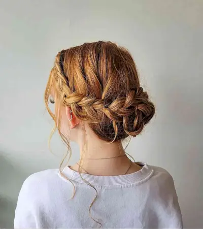 Low Braided Bun with Loose Strands for Graduation