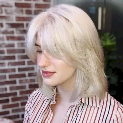 Shoulder-length straight hairstyle with curtain bangs