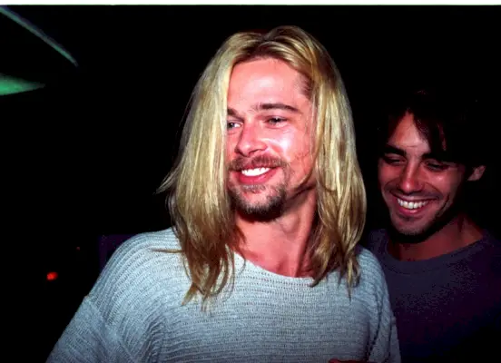Brad Pitt viser sit lange, blegede blonde hår frem, da han forlader natklubben Roxbury i 1994.