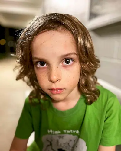 Shoulder-Length Wavy Hairstyle for Young Boys