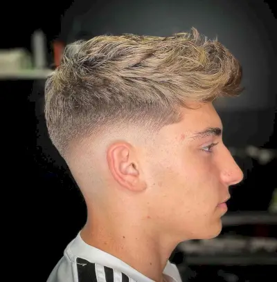 Messy Thick Curly Hair with a Mid Fade for Teens