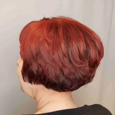 Ear-Length Layered Bob on Bright Red Hair