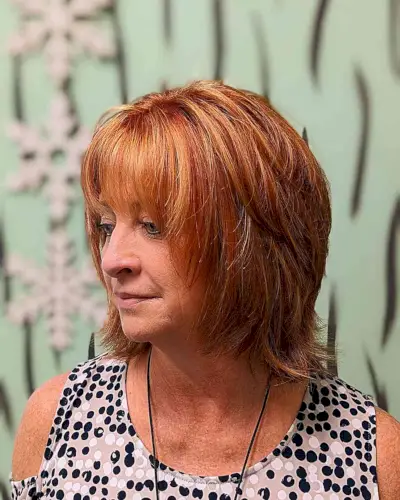 Red Layered Shaggy Bob with Blonde Highlights and Bangs for older women with short hair