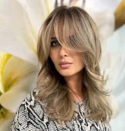Medium layered haircuts with side swept bangs