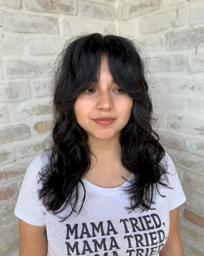 Trendy jet black shaggy layers with curtain bangs