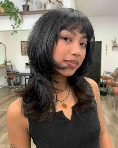 Feminine Face-Framing Short to Medium Layered Cut with Blunt Bangs