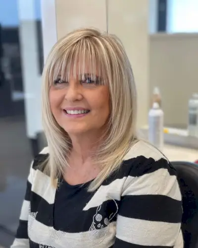 Short to medium layered shag cut with bangs for women over 50